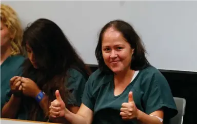  ?? (Photo by John Bazemore, AP) ?? Isabel Martinez gestures towards news cameras during her first court appearance Friday, July 7, 2017, in Lawrencevi­lle , Ga. Martinez is charged with killing four of her children and their father.