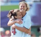  ?? ROBERT HANASHIRO/USA TODAY ?? Brandi Chastain leaps into the arms of teammate Carla Overbeck after nailing the winning kick in 1999.