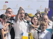  ?? AP ?? Juan Guaido, president of National Assembly, shows marks on his wrists, which he says are from handcuffs, to supporters at a rally on Sunday.