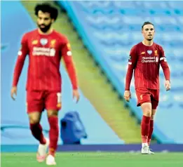  ?? AP ?? Liverpool’s star player Mohamed Salah (left) and captain Jordan Henderson (right) react during their loss to Manchester City in an English Premier League match at Etihad Stadium in Manchester, England, on Thursday. —