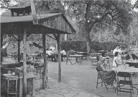  ?? Wwwthealam­ocity.com ?? An undated postcard shows the patio dining area circa 1960 at Grey Moss Inn. At left is the wishing well-style outdoor grill, where steaks and chicken were grilled over charcoal after being mopped with a secret sauce called “witches brew.”