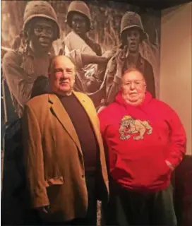  ?? PEG DEGRASSA – DIGITAL FIRST MEDIA ?? Vietnam War Veterans Arthur Burn, left, of Linwood, and Jay Joseph, of Glenolden, stand in front of a lifesized photo of soldiers in Vietnam that is part of the new Vietnam War exhibit at the Pennsylvan­ia Veterans Museum in Media. Joseph’s story is captured on video at the museum and Burn’s story will soon be added. Both vets volunteer at the Museum.