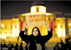  ?? THE ASSOCIATED PRESS ?? A woman holds up a sign reading “NOT IN MY NAME” at a Thursday vigil in London’s Trafalgar Square for the victims of Wednesday’s attack.