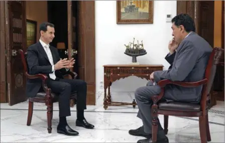  ?? SANA VIA AP ?? In this photo released Thursday by the Syrian official news agency SANA, Syrian President Bashar Assad speaks during an interview with Alexis Papachelas, the the executive editor of the Greek Kathimerin­i newspaper, in Damascus, Syria. In the interview...