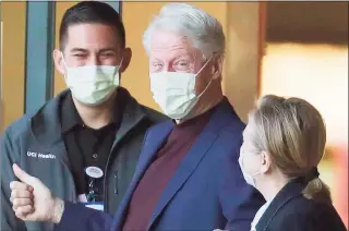  ?? Allen J. Schaben / TNS ?? Former President Bill Clinton, standing with his wife, Hillary, was discharged from UC Irvine Medical Center Sunday morning, six days after he was admitted and treated for a urological and blood infection.