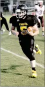  ?? MARK HUMPHREY ENTERPRISE-LEADER ?? Prairie Grove freshman halfback Cade Grant scored a trio of first half touchdown runs of 55 and 44 yards and this 4-yard burst to the left pylon in junior high football action against Huntsville on Thursday, Sept. 21. Grant finished with 307 yards...