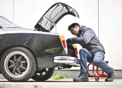  ?? Picture: AFP ?? WIN-WIN. A mechanic works on a conversion of a Volkswagen Karmann Ghia at the London Electric Cars garage in central London recently.