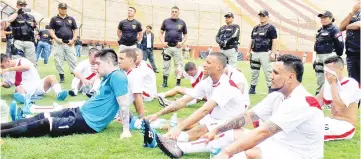  ?? — AFP photo ?? Inmates from the Peruvian prison of Lurigancho (playing for Peru) take a break under heavy guard, during their ‘First Inter-prison World Cup Russia 2018’ final against inmates from Chimbote prison (playing for Russia), at the Monumental stadium in Lima.