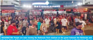  ?? — AFP ?? WASHINGTON: People are seen leaving the Nationals Park stadium as the game between the Nationals and the San Diego Padres was interrupte­d due to a shooting outside the stadium in Washington, DC, on Saturday.