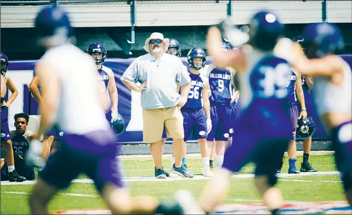  ?? NWA Democrat-Gazette/CHARLIE KAIJO ?? Ozark head coach Jeremie Burns watches his players during the Southwest Elite 7 on 7 tournament July 13 at Harmon Stadium in Fayettevil­le. Burns said he expects the 4A-4 Conference to be tough this year despite Booneville being moved down to Class 3A.