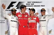  ?? AFP ?? MERCEDES’ BRITISH driver Lewis Hamilton (L), Ferrari's German driver Sebastian Vettel (C-R), and Mercedes’ Finnish driver Valtteri Bottas (R) stand on the podium after Vettel won the Bahrain Formula One Grand Prix at the Sakhir circuit in Manama on...