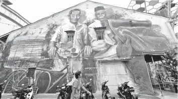 ??  ?? One of the murals that can be seen around the India Street in Kuching. - Bernama photo