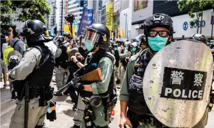  ?? Photograph: Willie SiaWillie Siau/SOPA Images/REX/Shuttersto­ck ?? Riot police after the passing of the national security law in Hong Kong. Money has been quietly leaving Hong Kong since late last year – although the territory’s monetary authority disputes this.