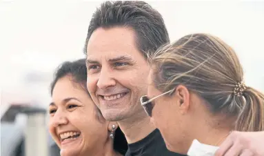  ?? FRANK GUNN THE ASSOCIATED PRESS ?? Michael Kovrig, centre, embraces his wife, Vina Nadjibulla, left, and sister Ariana Botha after arriving in Toronto Saturday.