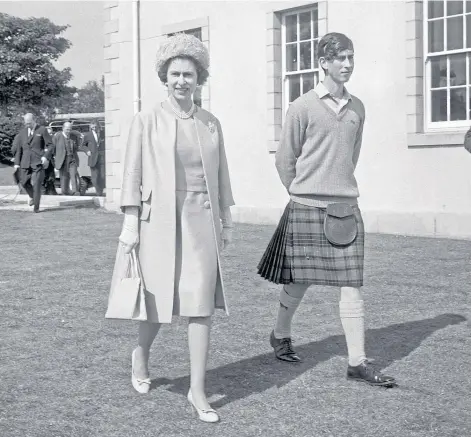  ??  ?? DAY OUT: The Queen and Prince Charles during one of the monarch’s visits to Gordounsto­un School, where Charles was a pupil from 1962.