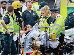  ??  ?? Injured: One victim is whisked away by ambulance crews