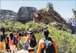  ?? Brian Farner ?? Hikers line up on the Angels Landing Trail at Zion National Park on May 28. More than 4.5 million people visited the Utah park in 2017.