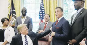  ??  ?? U.S. President Donald Trump jokes with actor Sylvester Stallone after pardoning former heavyweigh­t champion Jack Johnson in the Oval Office on Thursday. Also in the photo, from left: Linda Haywood, Johnson’s great-great niece, Deontay Wilder, Keith...