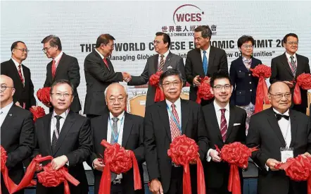  ??  ?? Friendly start: Liow shaking hands with Asli CEO and WCES chairman Tan Sri Michael Yeoh at the opening ceremony of WCES at Shangri la Hotel in Hong Kong. With them are (back, from right) Asli and Sunway Group chairman Tan Sri Jeffrey Cheah, Hong Kong...