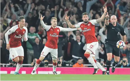  ?? AP PHOTO ?? START IT UP: Arsenal’s Olivier Giroud (second right) celebrates as referee Mike Dean says his shot crossed the line, capping a wild come-from-behind 4-3 victory over Leicester City to open the Premier League season.