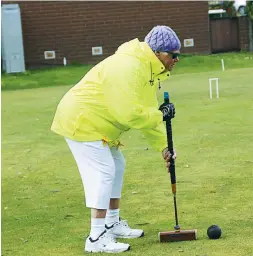  ??  ?? Above: New player for Drouin Michael Fry has made a successful start to croquet, reducing his handicap in the first round.
Left: Rugging up to combat the cold conditions, Drouin player Heather Bullen takes a shot.
Below: Warragul player Russ Marriott...