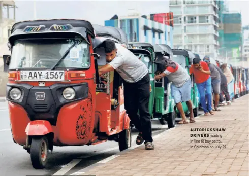  ?? ?? AUTORICKSH­AW DRIVERS waiting in line to buy petrol, in Colombo on July 29.