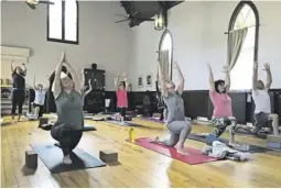  ??  ?? A Vinyasa Flow yoga class, one of several offered inside the old abbey.