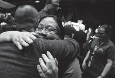  ?? Mario Tama / Getty Images ?? Jennifer Herman, NASA power subsystem operations lead for the rover Opportunit­y, hugs a colleague at a news conference announcing the conclusion of the mission on Wednesday.