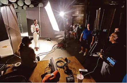  ?? James Nielsen / Houston Chronicle ?? Kashmere High School drum major Zackery Johnson takes part in the filming of a commercial this month at South Coast Film & Video in Houston. By one estimate, film business in Houston has a local economic impact that’s as high as $60 million a year.