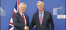  ?? AFP ?? Britain's Brexit Minister David Davis (left) and EU’s Michel Barnier shake hands in Brussels on Monday ahead of talks