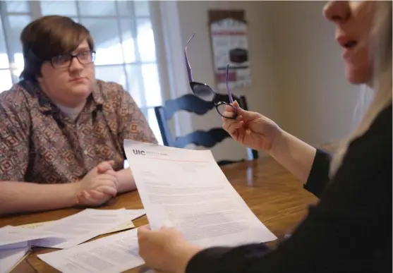  ??  ?? Stinging criticism Cynthia Mallard and her son Luke with documents from his UIC case file. JOSHUA LOTT/ PROPUBLICA ILLINOIS