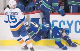  ??  ?? Left, top and bottom: Vancouver’s Brock Boeser suffers a season-ending injury Monday as a check from the New York Islanders’ Cal Clutterbuc­k sends him into the open gate at the Canucks’ bench. Right: Teammates look on as Boeser is helped from the ice...