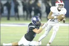  ?? NWA Democrat-Gazette/ANDY SHUPE ?? Fayettevil­le linebacker Dotson Schaefer (40) attempts to drag down Bishop Dunne quarterbac­k Kerry Wilkerson on Friday at Harmon Stadium in Fayettevil­le.