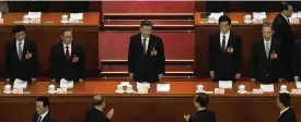  ?? ASSOCIATED PRESS ?? Delegates applaud as Chinese President Xi Jinping (center) arrives during a session of China’s National People’s Congress (NPC) at the Great Hall of the People in Beijing on Tuesday.