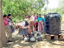  ??  ?? Puttalam District:Karauwalag­aswewa residents line up for drinking water