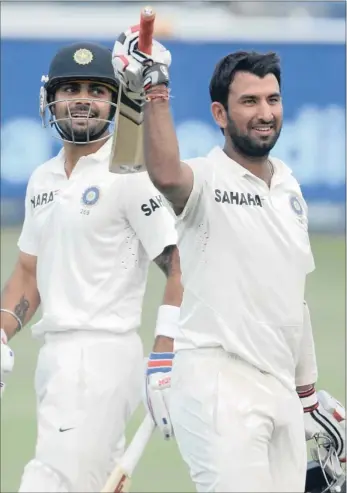  ?? GALLO IMAGES ?? PROTEAS PUNISHED: Cheteshwar Pujara, right, celebrates his 100 for India at the Wanderers. He went on to score 135 not out, sharing an unbroken stand of 191 with batting partner Virat Kohli.