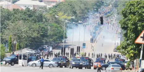  ?? Photo: Abubakar Yakubu ?? Policemen shoot tear gas to disperse members of the Islamic Movement in Nigeria, during the sect’s protest in Abuja yesterday.