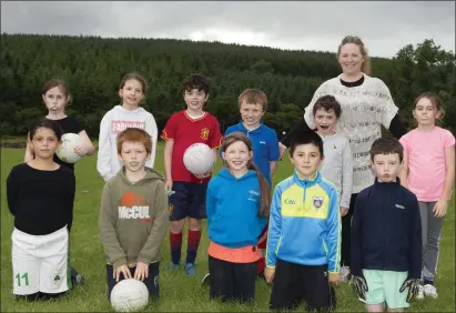  ??  ?? Lacken-Kilbride under-9s with coach Sinead Eustace at the club’s first training session at their new pitch on Monday.