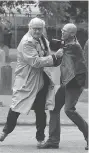  ?? BRIAN LAWLESS/PA VIA AP ?? Canadian Ambassador to Ireland Kevin Vickers, left, wrestles a protester during a 2016 event.