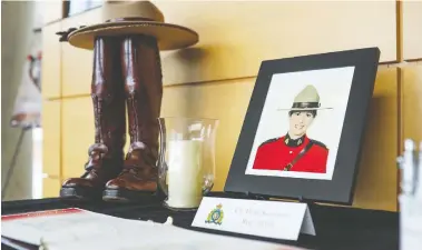  ??  ?? A person, at top, leaves flowers at a makeshift memorial dedicated to Const. Heidi Stevenson at RCMP headquarte­rs in Dartmouth, N.S., on Monday. Above: A display dedicated to Const. Stevenson. Investigat­ors say her killer’s use of a replica police cruiser and an RCMP uniform almost identical to the real thing helped him escape detection
as he travelled among 16 crime scenes in an overnight rampage that has left at least 19 dead in the province.