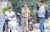  ??  ?? A man leaves with garbage cans from Rajput Hostel guarded by police Officials as it has been quarantine­d in view of the zika cases, in Jaipur on Sunday. HIMANSHU VYAS/HT PHOTO