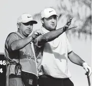  ?? Steve Dykes / Getty Images ?? Scottie Scheffler, right, the former University of Texas star in his first year on the PGA Tour, is tied for the lead after two rounds of the tournament.