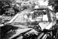  ??  ?? Taxi driver Kazuyo Saito poses inside her taxi in Tokyo.