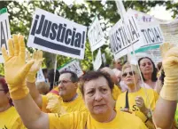  ?? (Juan Medina/Reuters) ?? PEOPLE PROTEST Spain’s ‘stolen babies’ scandal outside a court in Madrid yesterday.