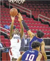  ?? CRAIG KOHLRUSS AP ?? SDSU’S Terrell Gomez (13 points) hits a 3-point attempt against Fresno State on Saturday.