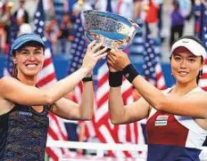  ?? AP ?? Martina Hingis (left) and Chan Yung-jan hold up the women’s doubles trophy after beating Czech Republic’s Katerina Siniakova and Lucie Hradecka in the final.