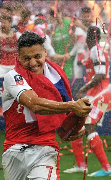  ??  ?? CHAMPAGNE MOMENT: Alexis Sanchez celebrates Arsenal’s FA Cup final win.