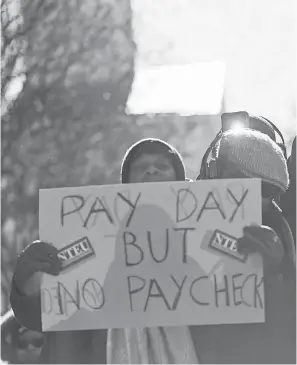  ?? PABLO MARTINEZ MONSIVAIS/AP ?? Union members and other federal employees rally to call for an end to the partial government shutdown on Thursday at AFL-CIO headquarte­rs in Washington.