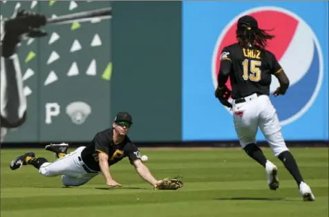  ?? Gerald Herbert/Associated Press ?? Bryan Reynolds dives for a bloop hit off a New York Yankees bat Thursday in a split squad game at LECOM Park in Bradenton, Fla. The Pirates lost to the Yankees, 9-1.