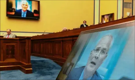  ?? Jacquelyn Martin / Associated Press ?? Darren Woods, CEO of Exxonmobil, testifies Thursday via video conference during a House Committee on Oversight and Reform hearing on the role of fossil fuel companies in climate change, with Rep. Ralph Norman, R-S.C., at left, in Washington.